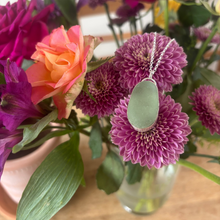 Load image into Gallery viewer, Seaglass pendant on flowers